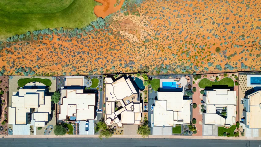 Aerial perspective showcasing a collection of properties bordering a natural desert landscape