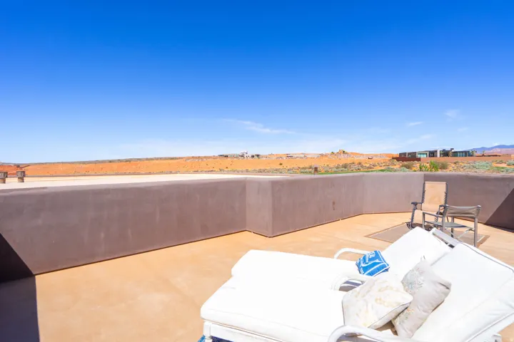 Expansive rooftop patio featuring neutral-toned concrete flooring and low perimeter walls