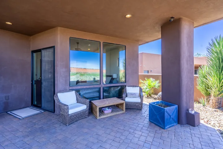 Covered patio featuring paver flooring, recessed lighting, and a large support column