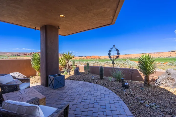 Covered patio with recessed lighting and a stone paver surface