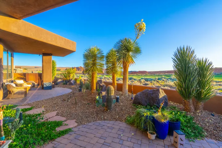 Exterior patio featuring desert landscaping, a covered outdoor area, and a paver patio surface