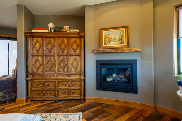 Built-in fireplace with a rustic wood mantel