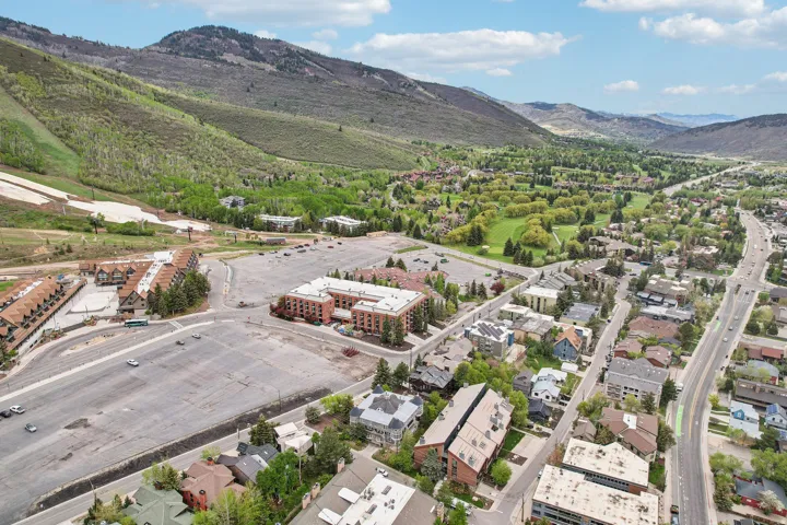 Aerial perspective showcasing a vibrant community nestled among verdant mountains