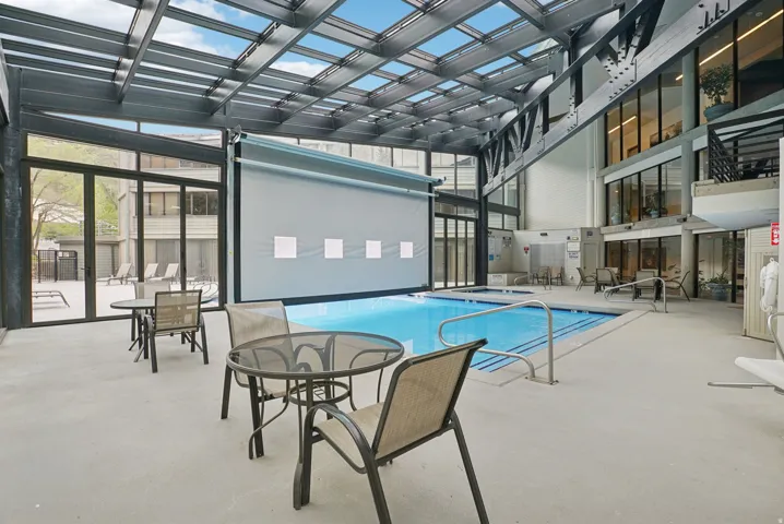 Indoor swimming pool with an overhead glass and metal roof structure