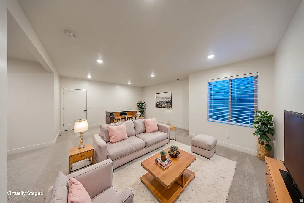 Virtually Staged. Spacious room featuring light-colored walls and carpeted flooring