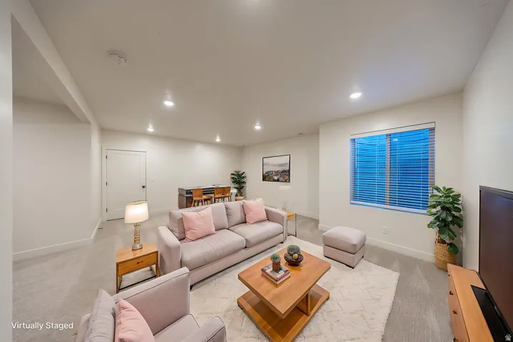 Virtually Staged. Spacious room featuring light-colored walls and carpeted flooring