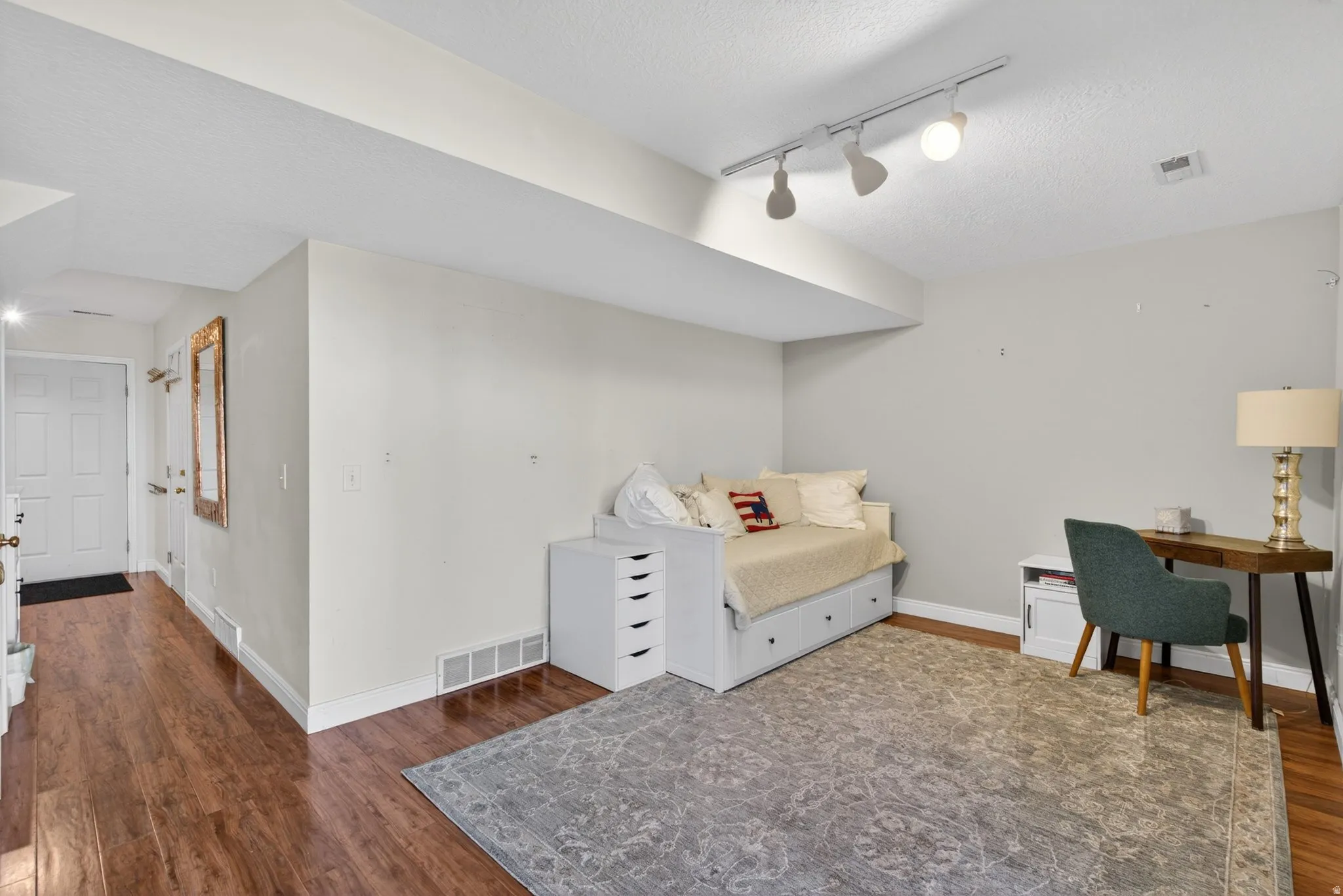 Hardwood-finish flooring extending into the hallway, with light gray walls and white baseboards