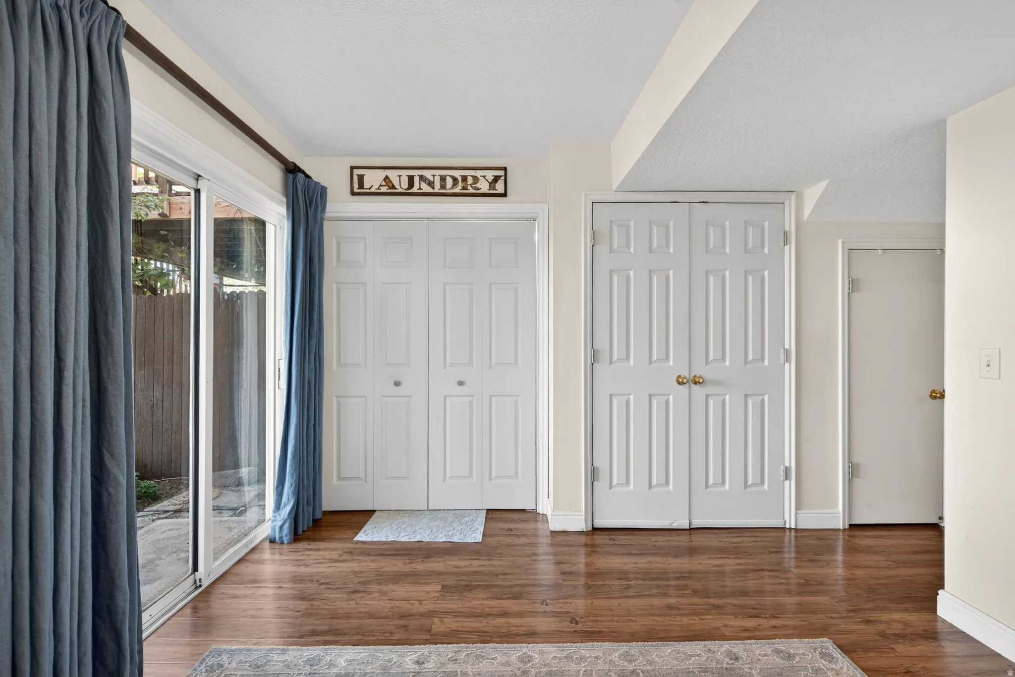 Sliding glass patio door with wood-finish flooring