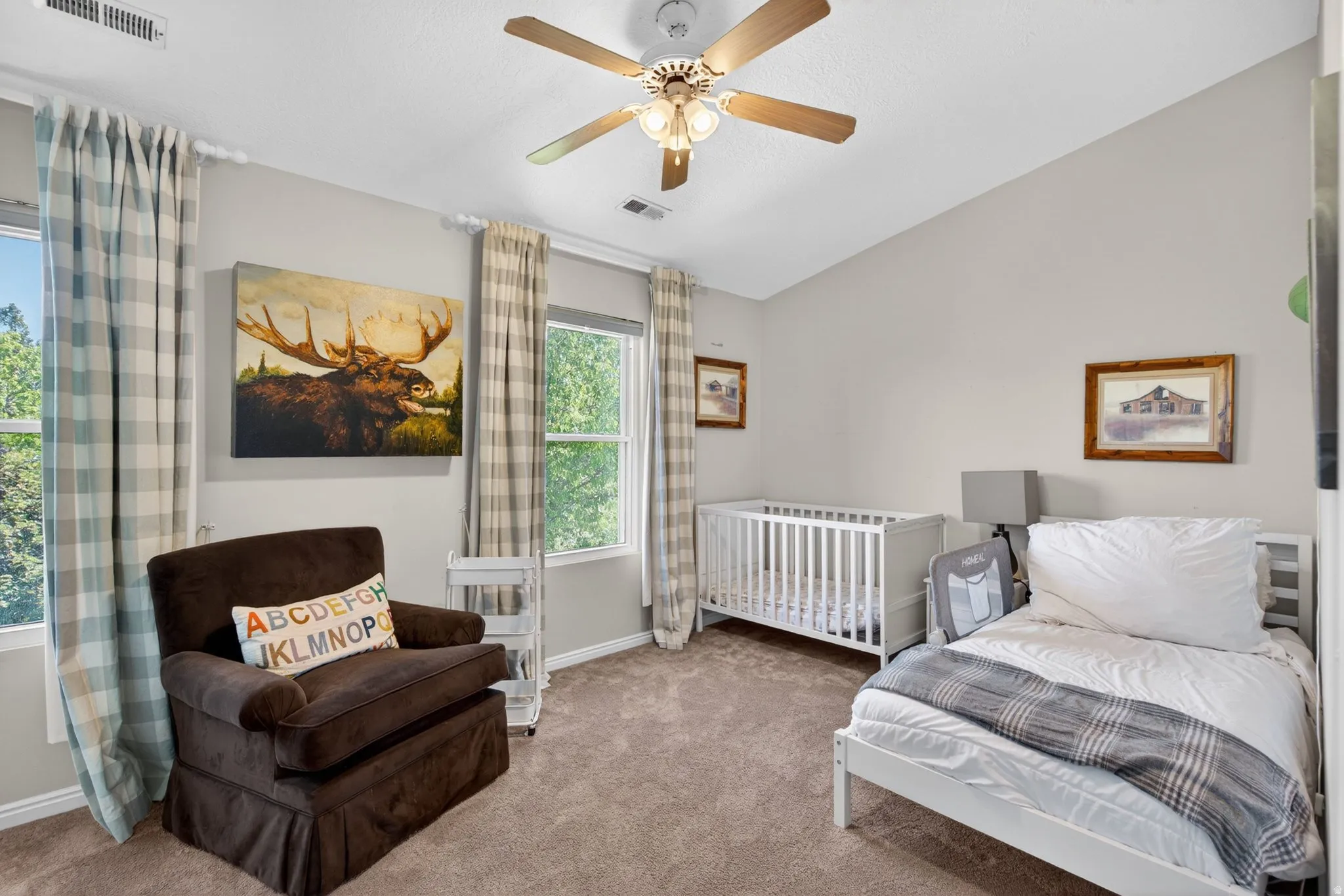 Carpeted room featuring a vaulted ceiling and a ceiling fan