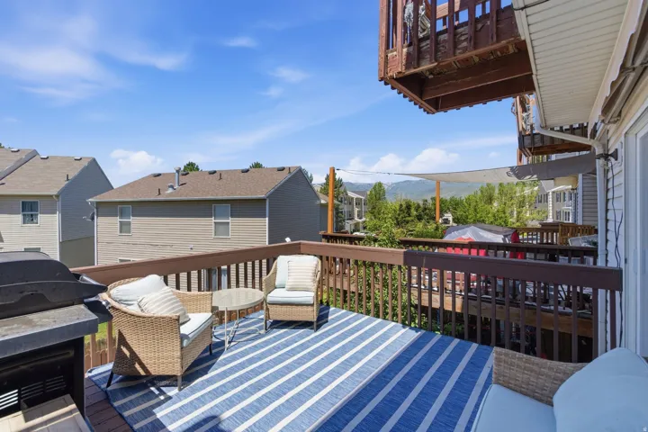 Spacious wooden deck with a built-in outdoor grill and a privacy lattice