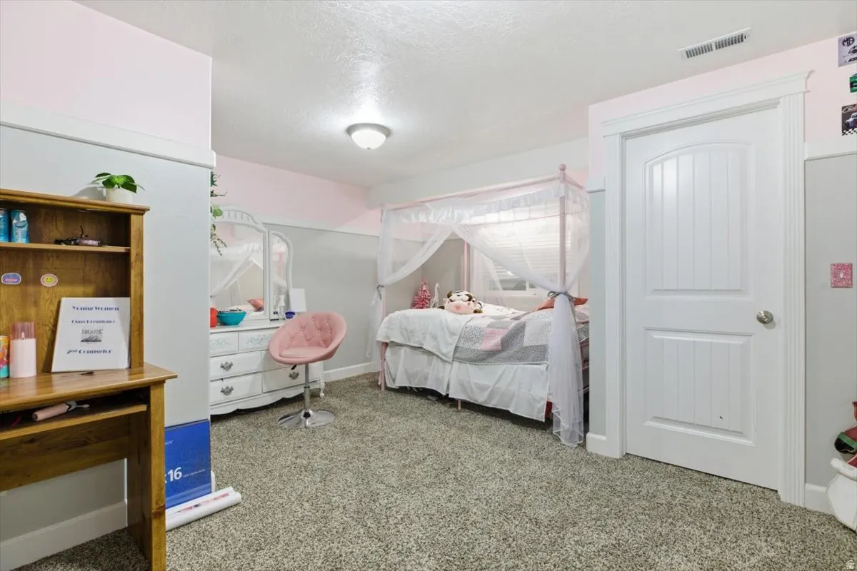 Spacious room featuring neutral carpet flooring and white baseboards
