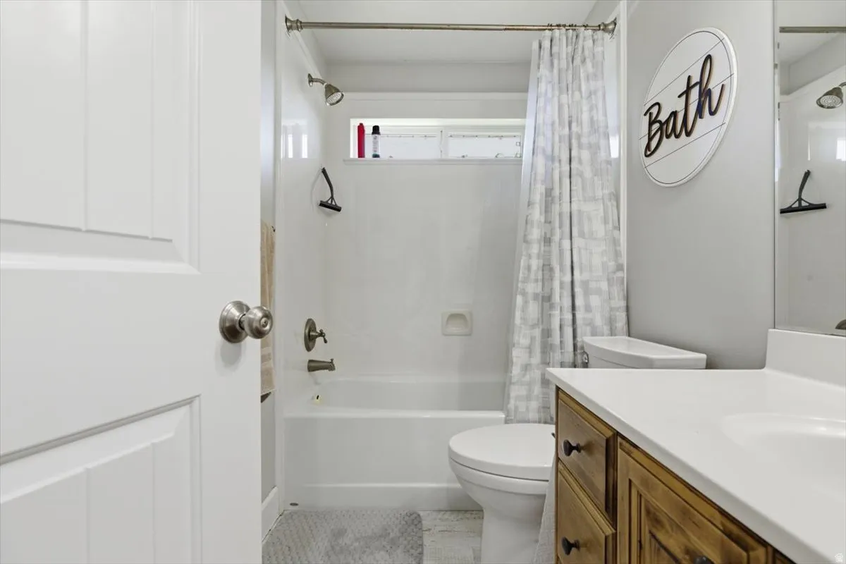 Bathroom featuring a white bathtub and shower combination with a single shower head