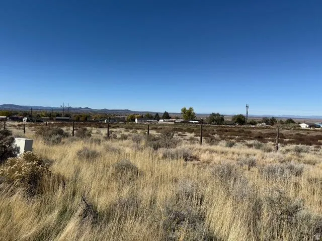 Expansive land parcel featuring natural grasses and sparse brush