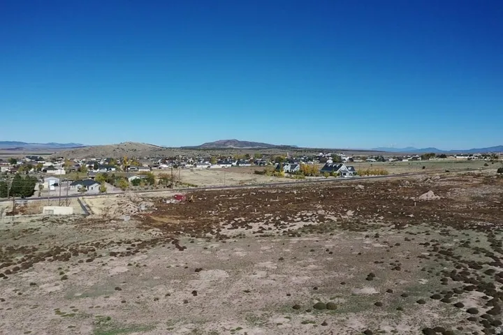Expansive undeveloped land featuring natural arid vegetation and scattered rock formations