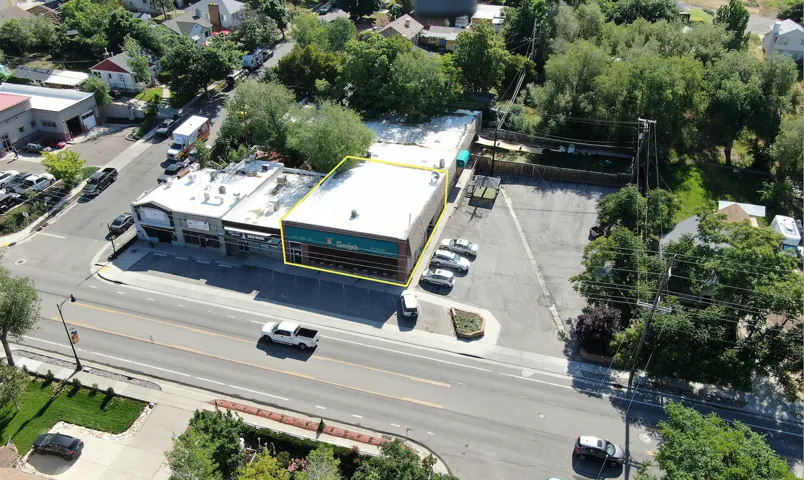 Commercial building with a prominent street presence and an expansive asphalt parking lot