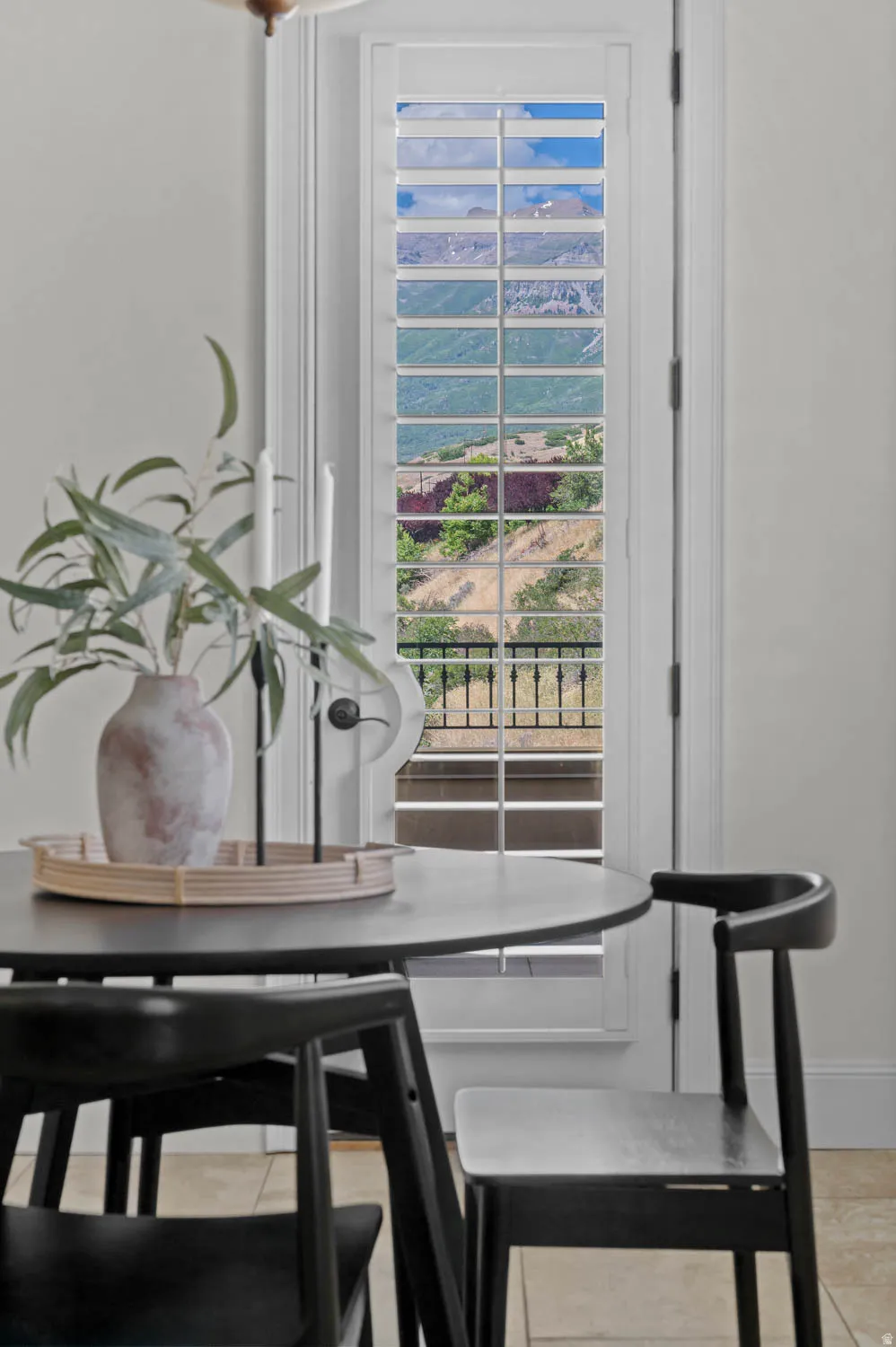 White door with integrated louvered shutters, offering controlled natural light