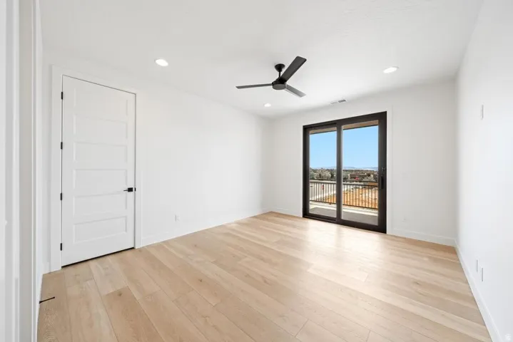 Light wood-finish flooring complements the bright white walls and ceiling