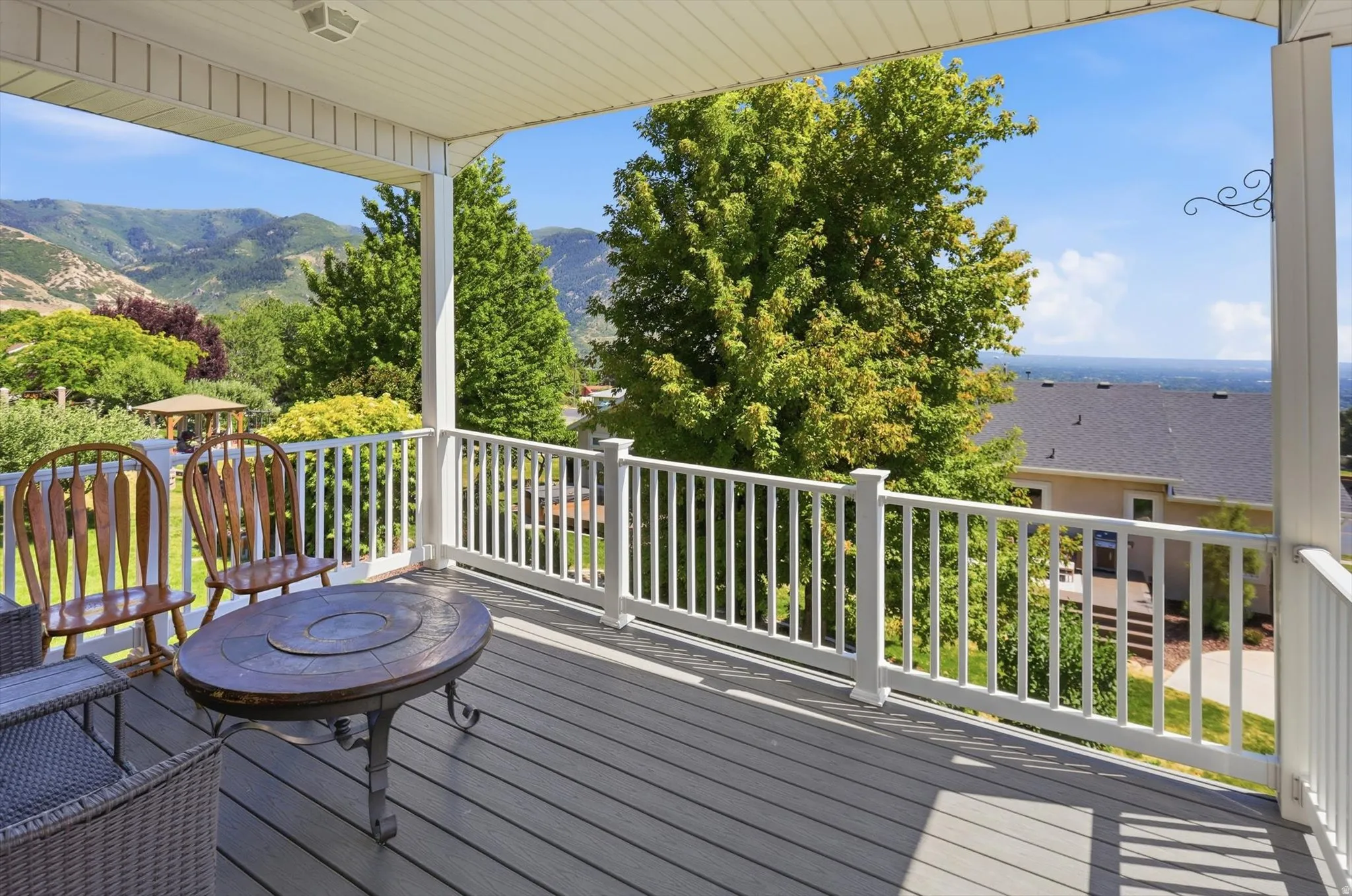 Covered outdoor deck with expansive mountain scenery