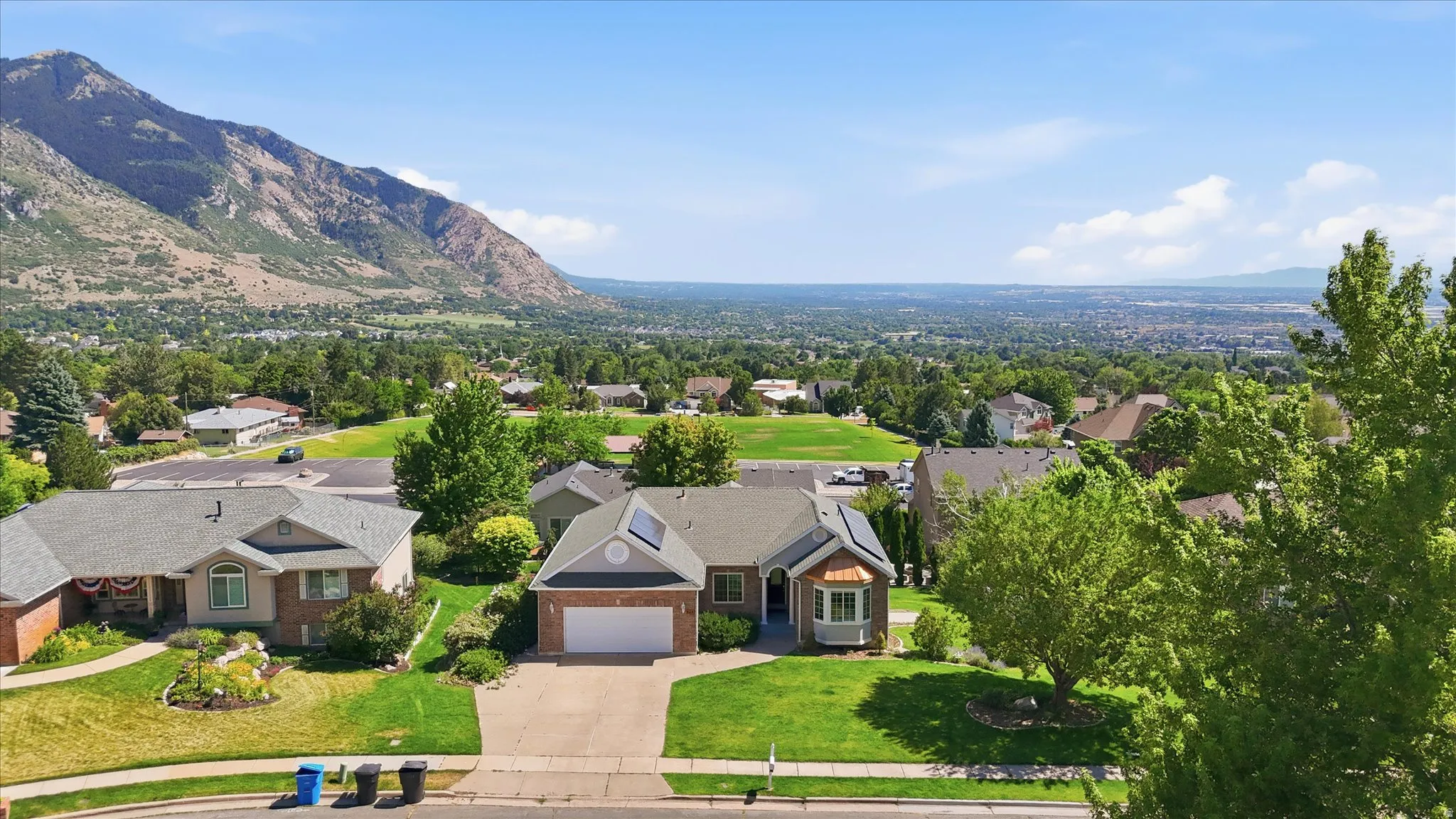 Contemporary ranch-style home featuring a brick and siding exterior, an attached garage, and a bay window