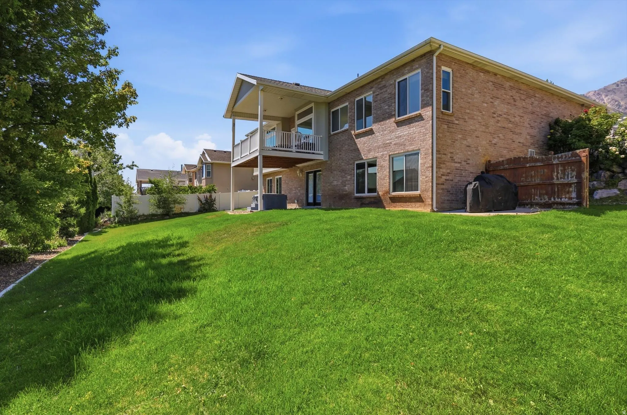 Spacious rear yard featuring a multi-level deck and patio