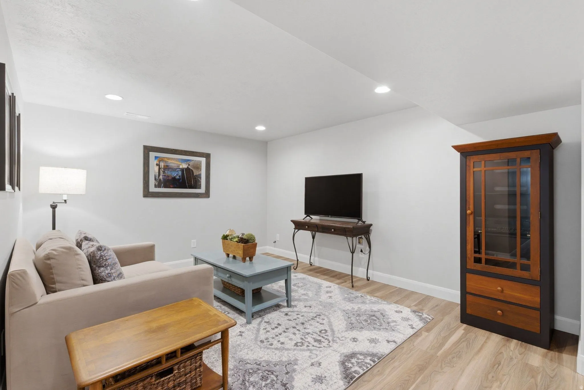 Living area featuring recessed lighting, light wood-finish flooring, and white baseboards
