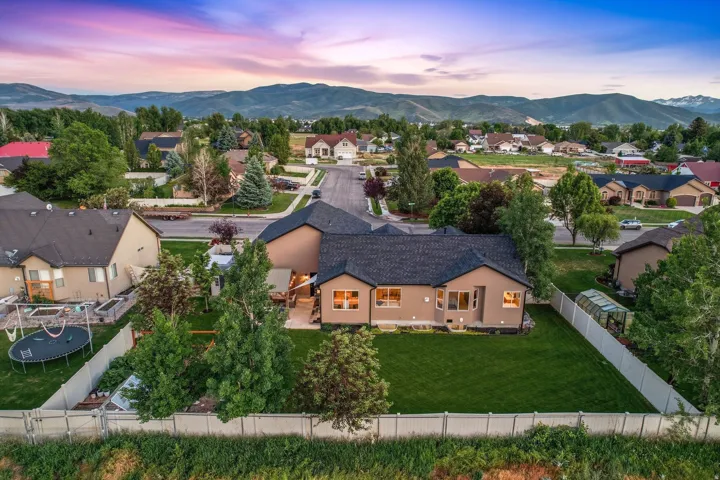 Spacious property featuring a large manicured lawn, a covered patio, and a greenhouse structure
