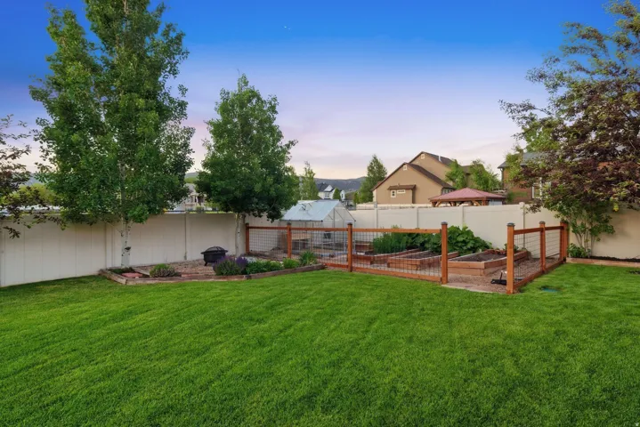 Manicured lawn with a white privacy fence