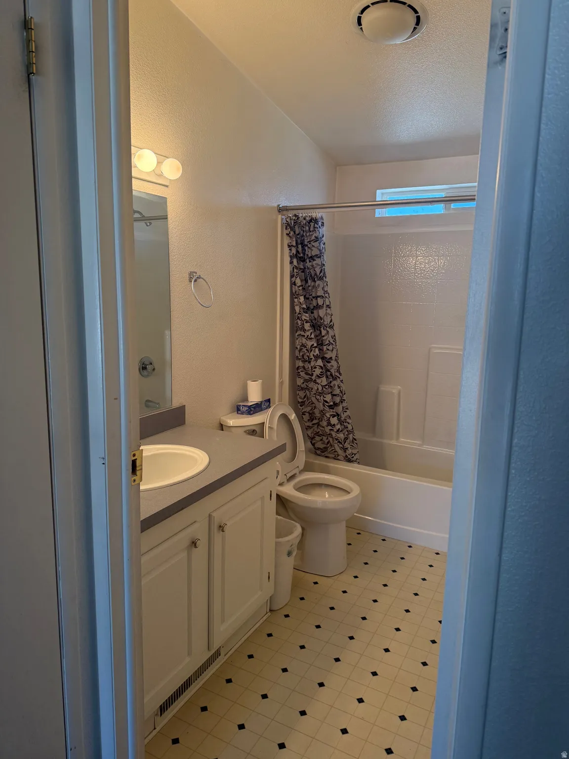 Bathroom 2 featuring a single vanity, integrated sink, and white cabinetry