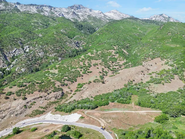 Mountainous terrain with varying elevations, verdant foliage, and visible rock formations