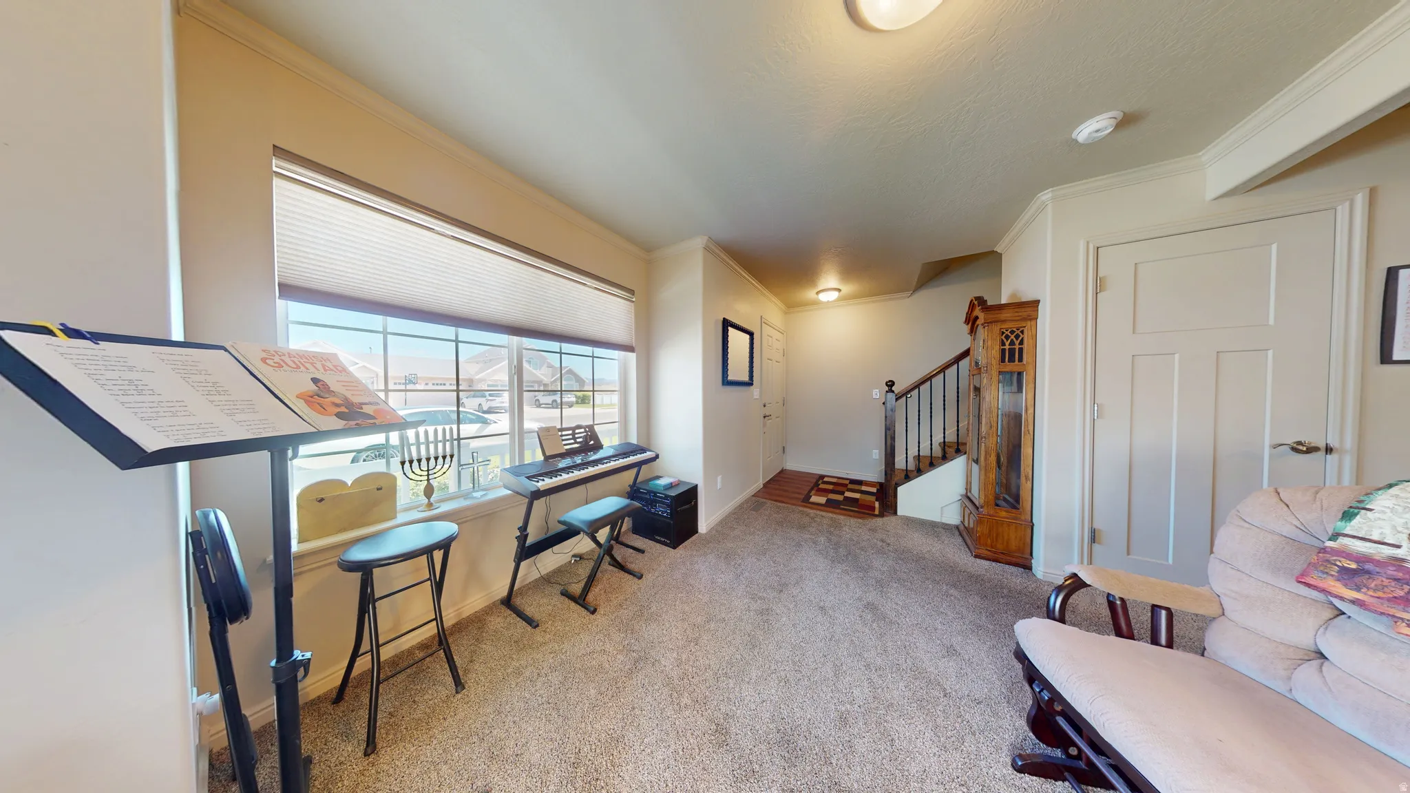 Windowed living space featuring carpet flooring, crisp white trim, and neutral wall tones