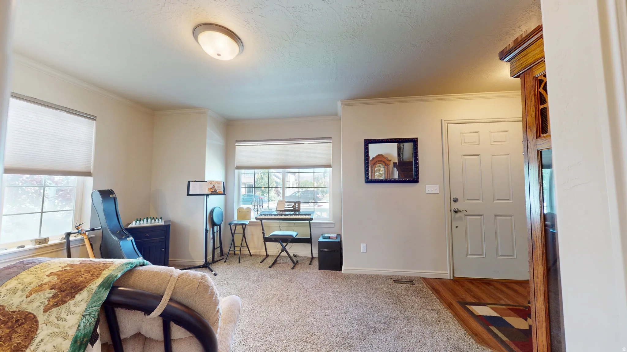 Entry area featuring a paneled door with brushed nickel hardware, wood-finish flooring, and a flush-mount ceiling light fixture