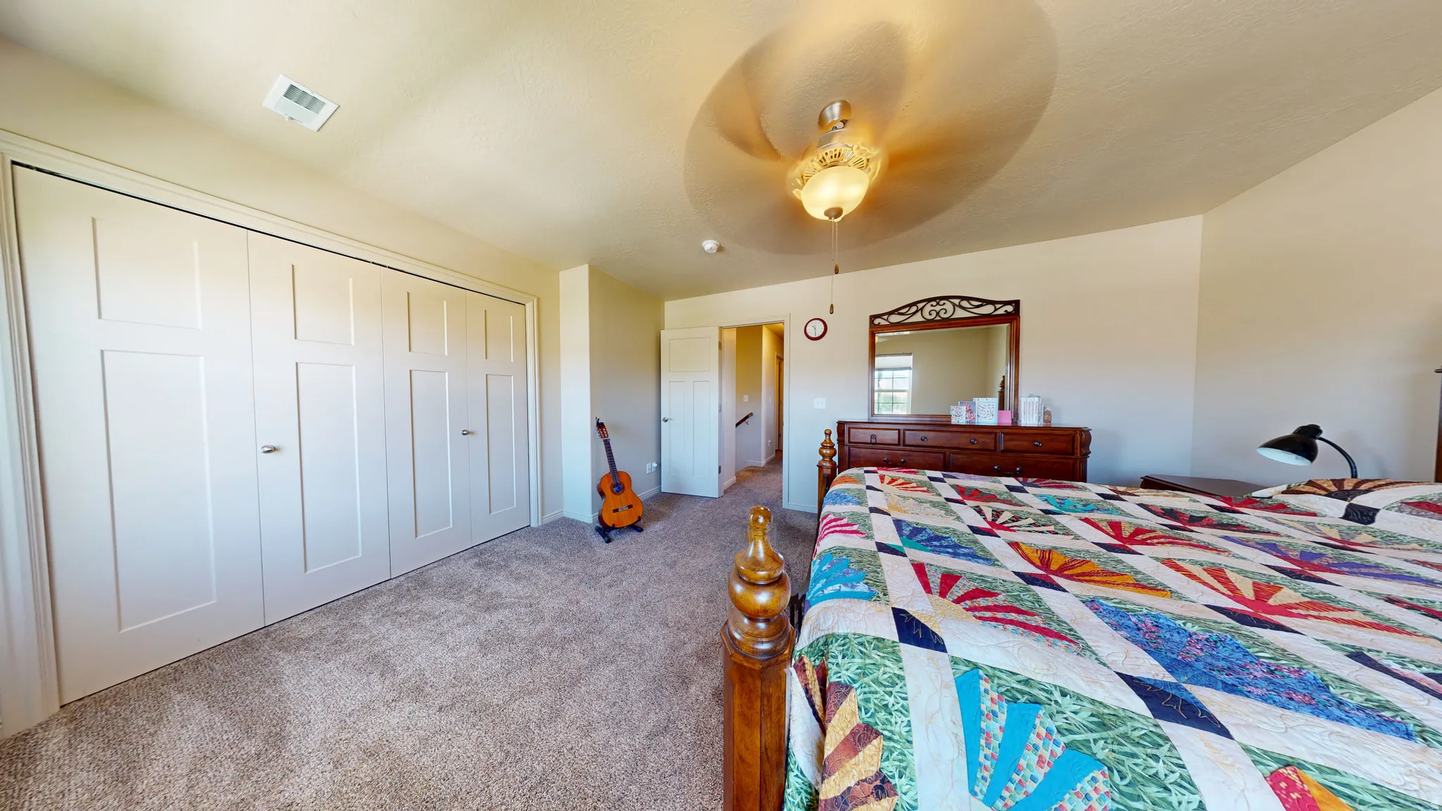 Spacious room featuring neutral carpeting and light-toned walls