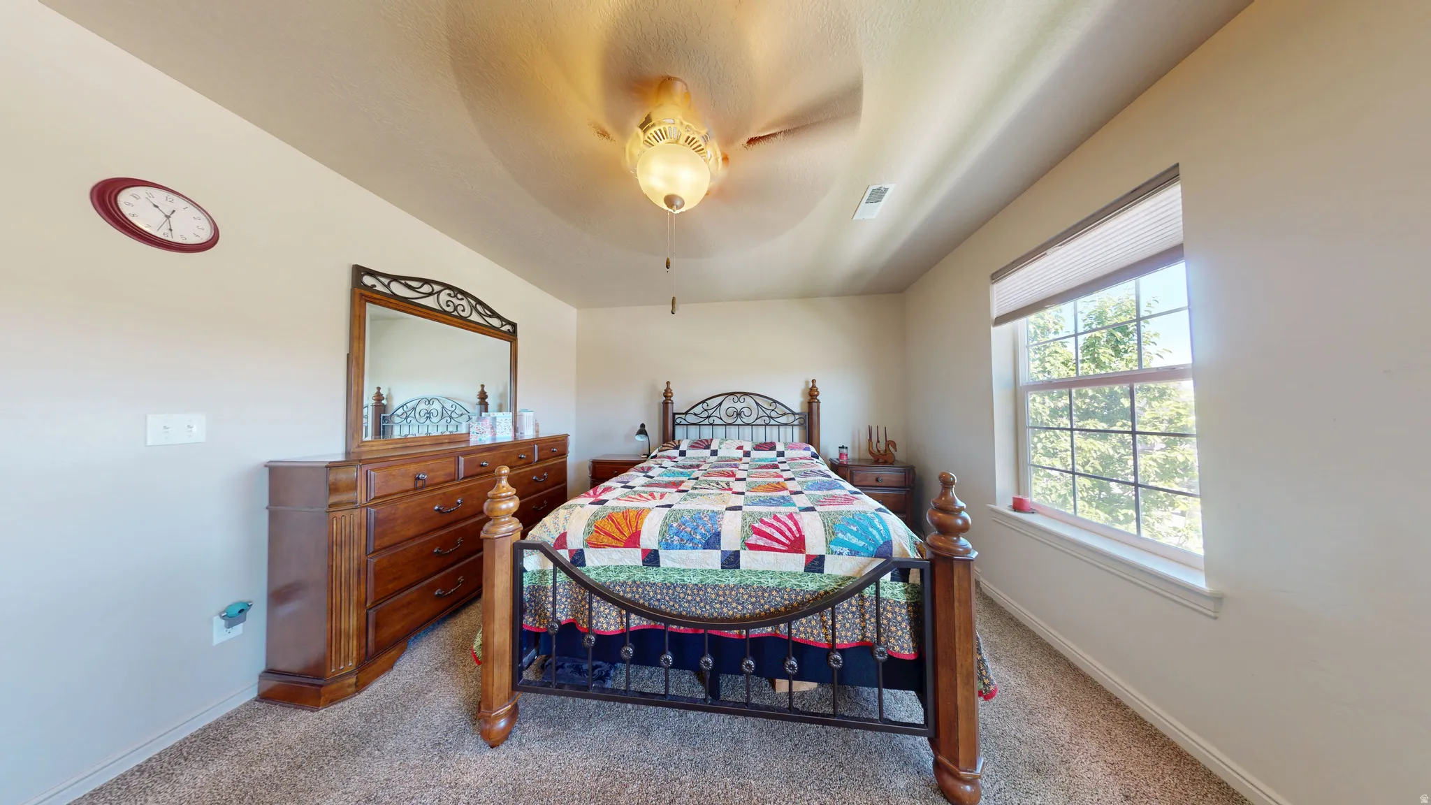 Carpeted room featuring light-colored walls and a window with blinds