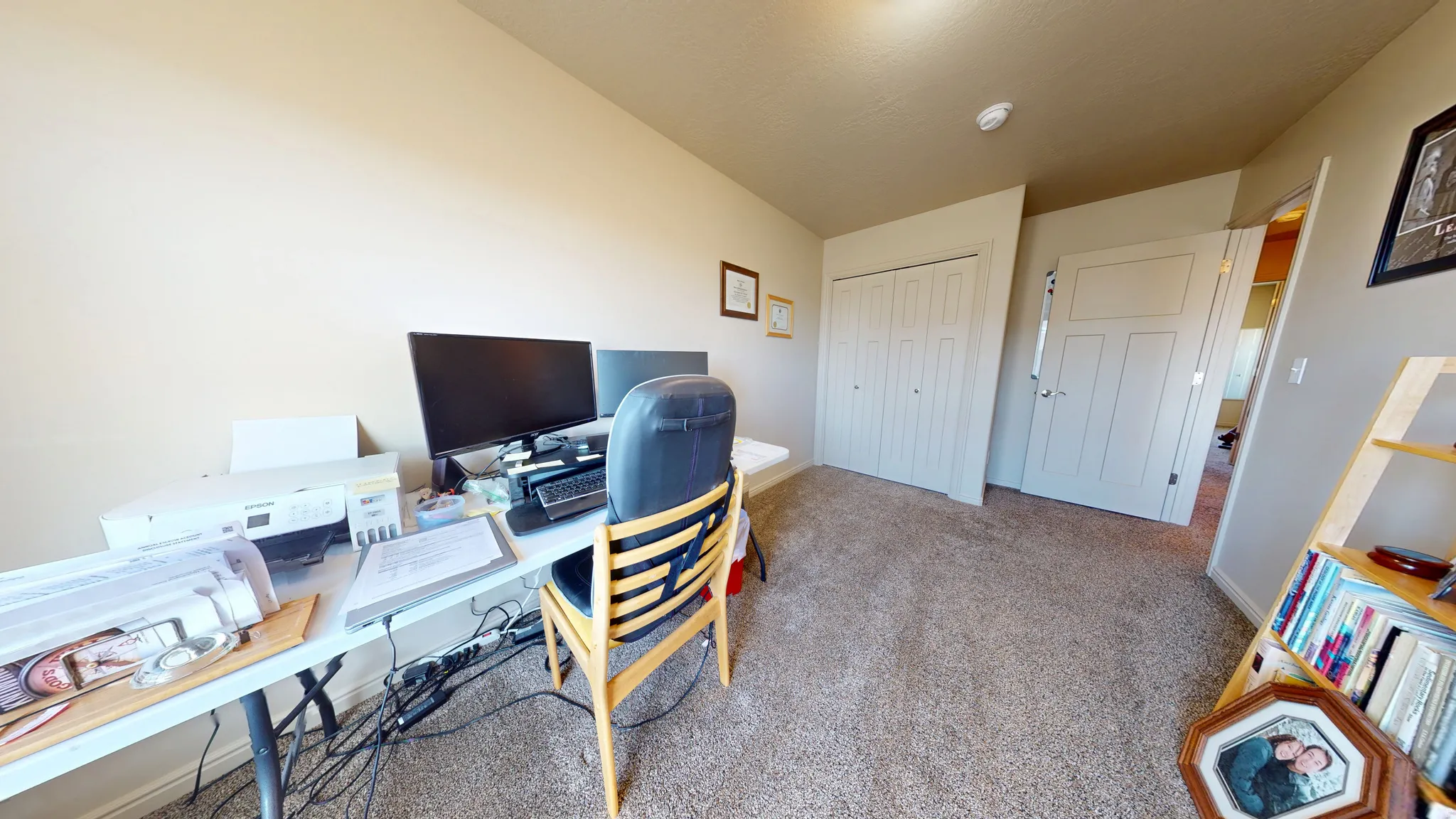 Carpeted room with neutral wall paint and white trim