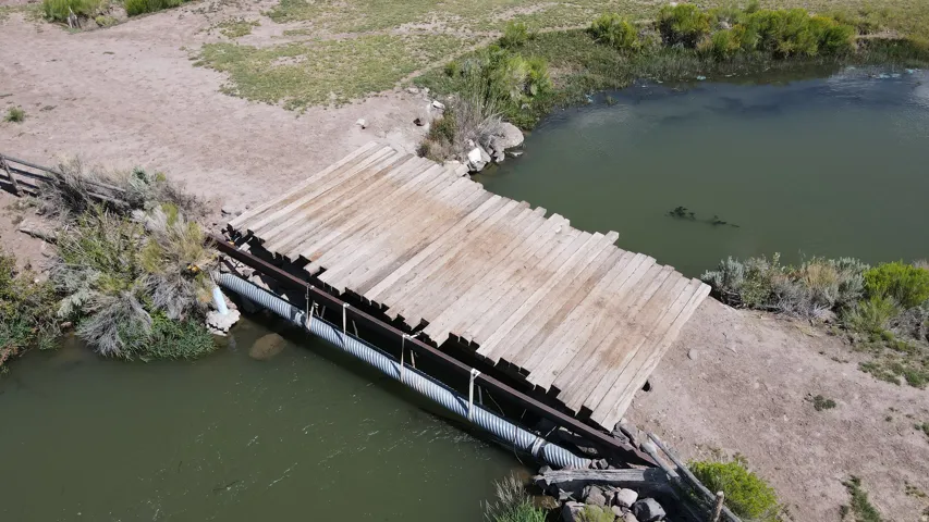 Wooden bridge spanning a natural water feature
