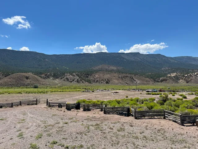 Expansive open landscape featuring distant mountains and a broad valley