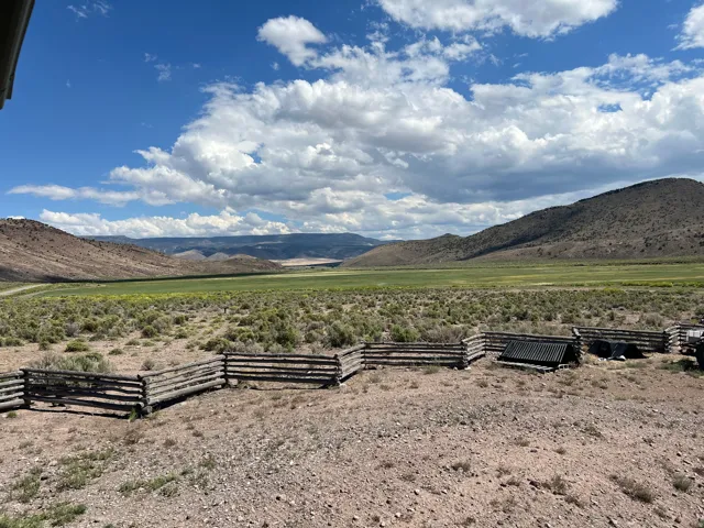 Expansive landscape featuring distant mountains and a broad valley