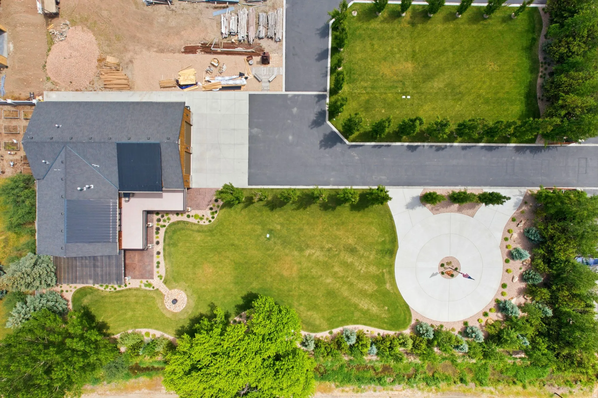 Expansive property featuring a large residence with dark shingle roofing and solar panels