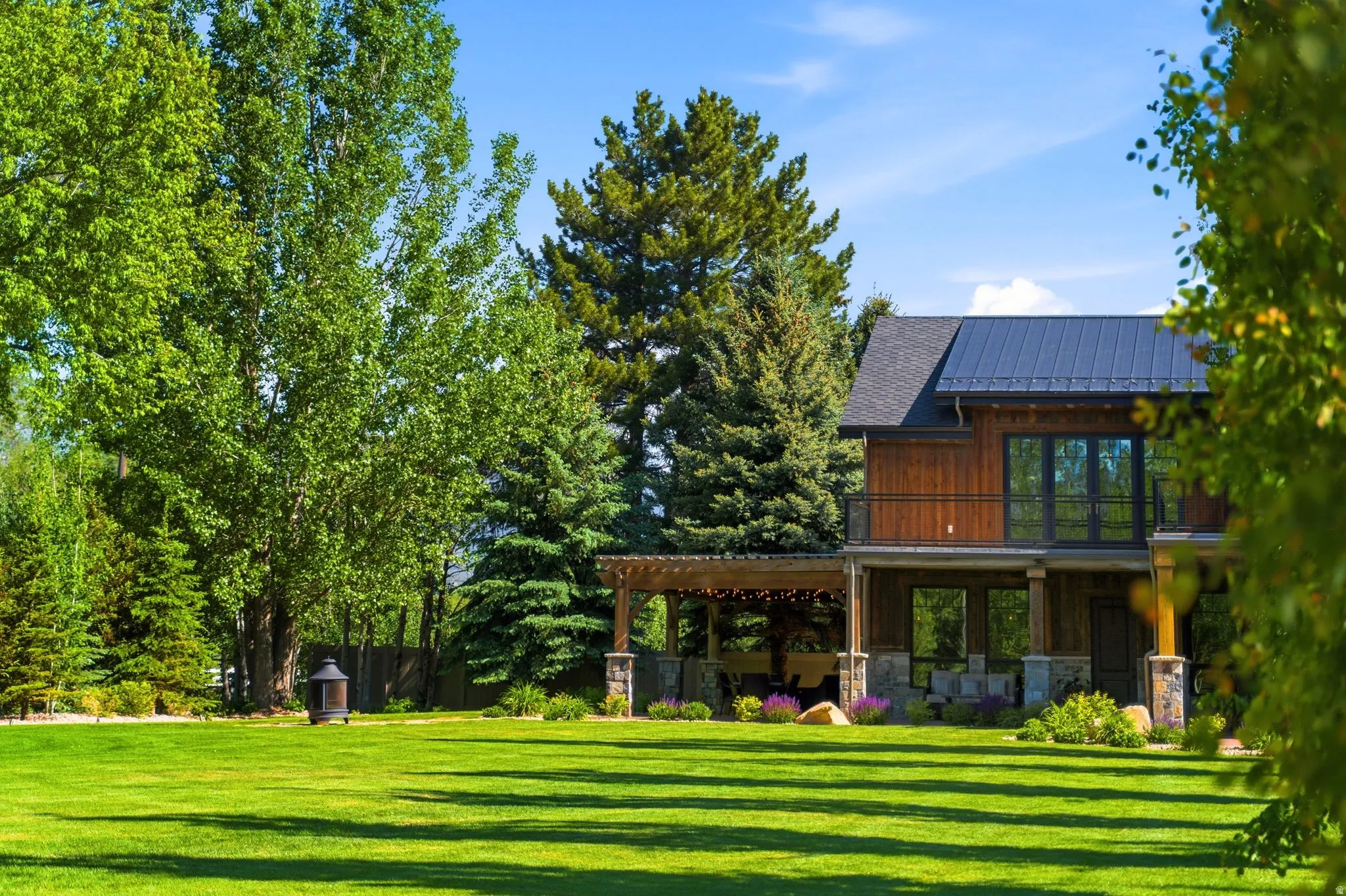 Spacious green lawn with mature trees