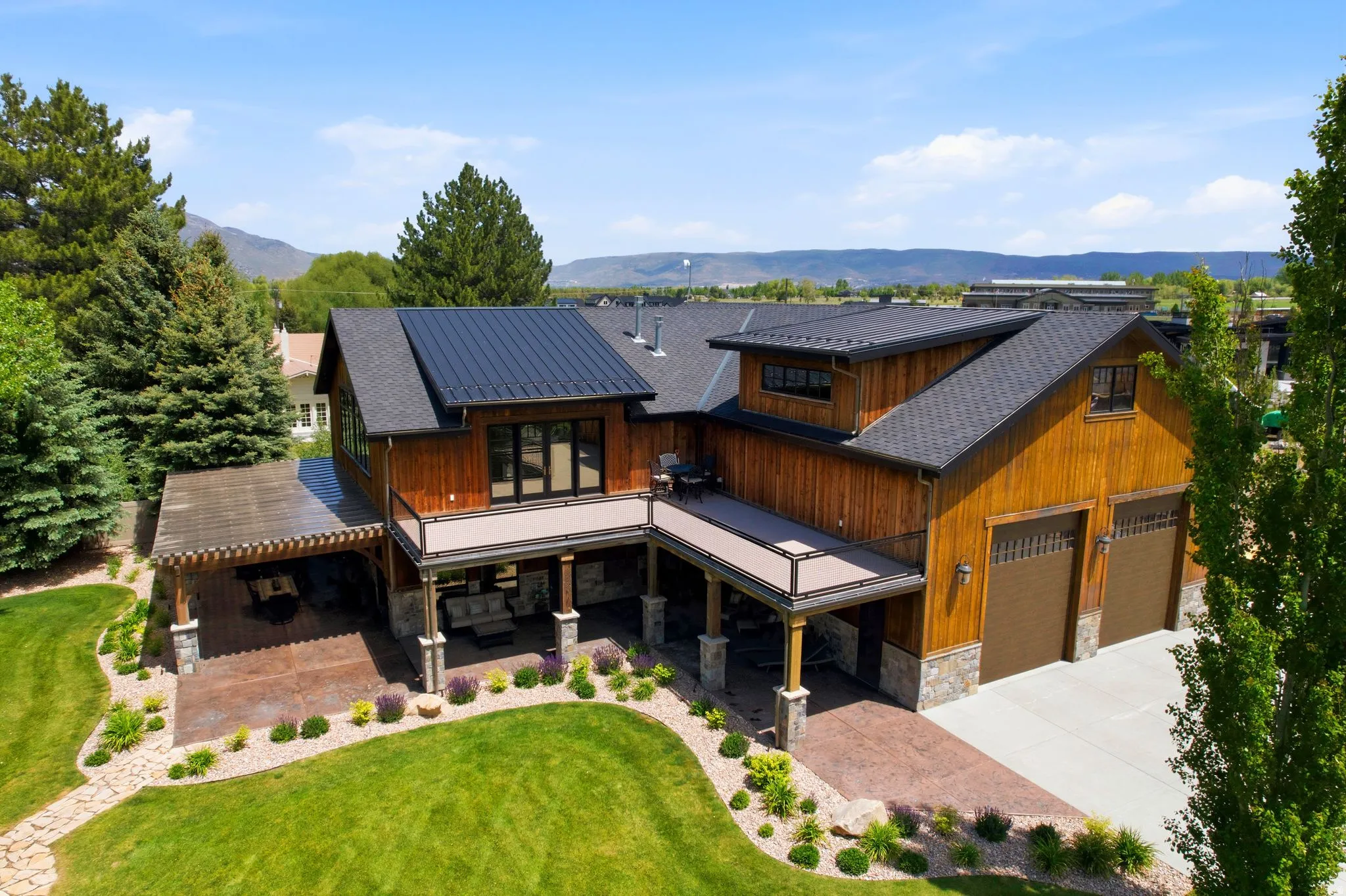 Contemporary residence featuring wood siding and a metal roof