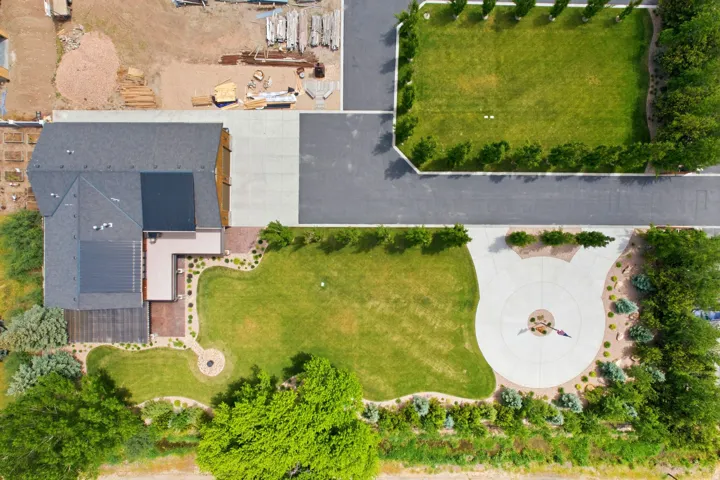 Expansive property featuring a large residence with dark shingle roofing and solar panels