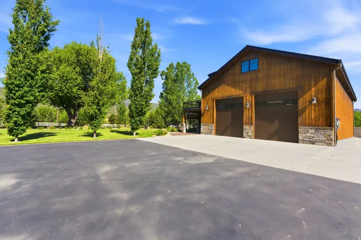 Barn-style structure featuring rich wood siding and a stone-clad foundation