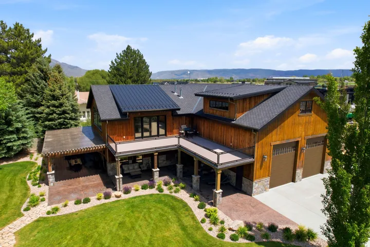 Contemporary residence featuring wood siding and a metal roof