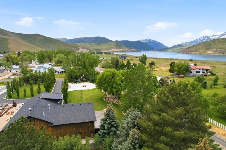Aerial perspective showcasing the property's expansive grounds, a long paved driveway, and mature landscaping