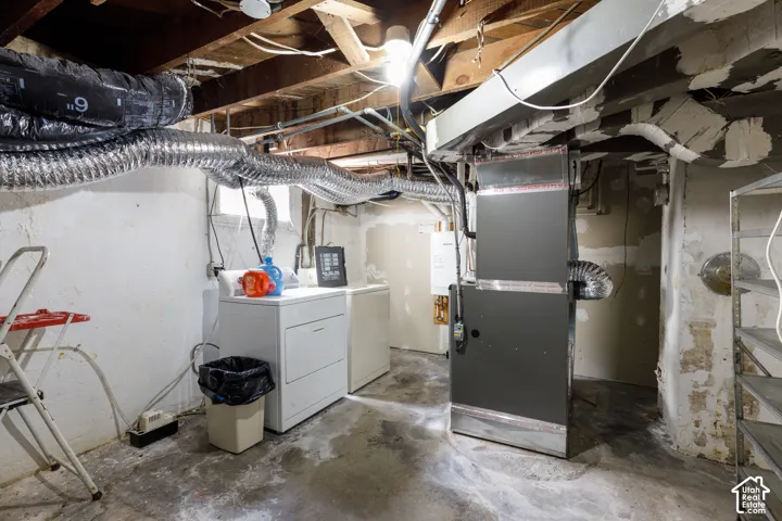 Basement utility room featuring exposed ceiling joists, white painted concrete walls, and concrete flooring
