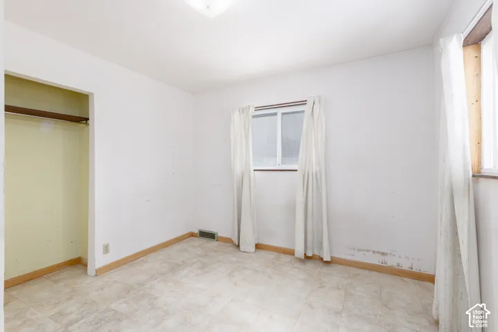 Neutral white walls and light-toned flooring define this room