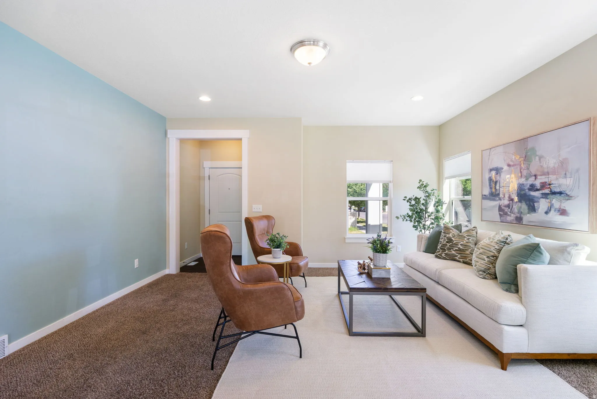 Living space with neutral-toned walls, recessed lighting, and a prominent accent wall