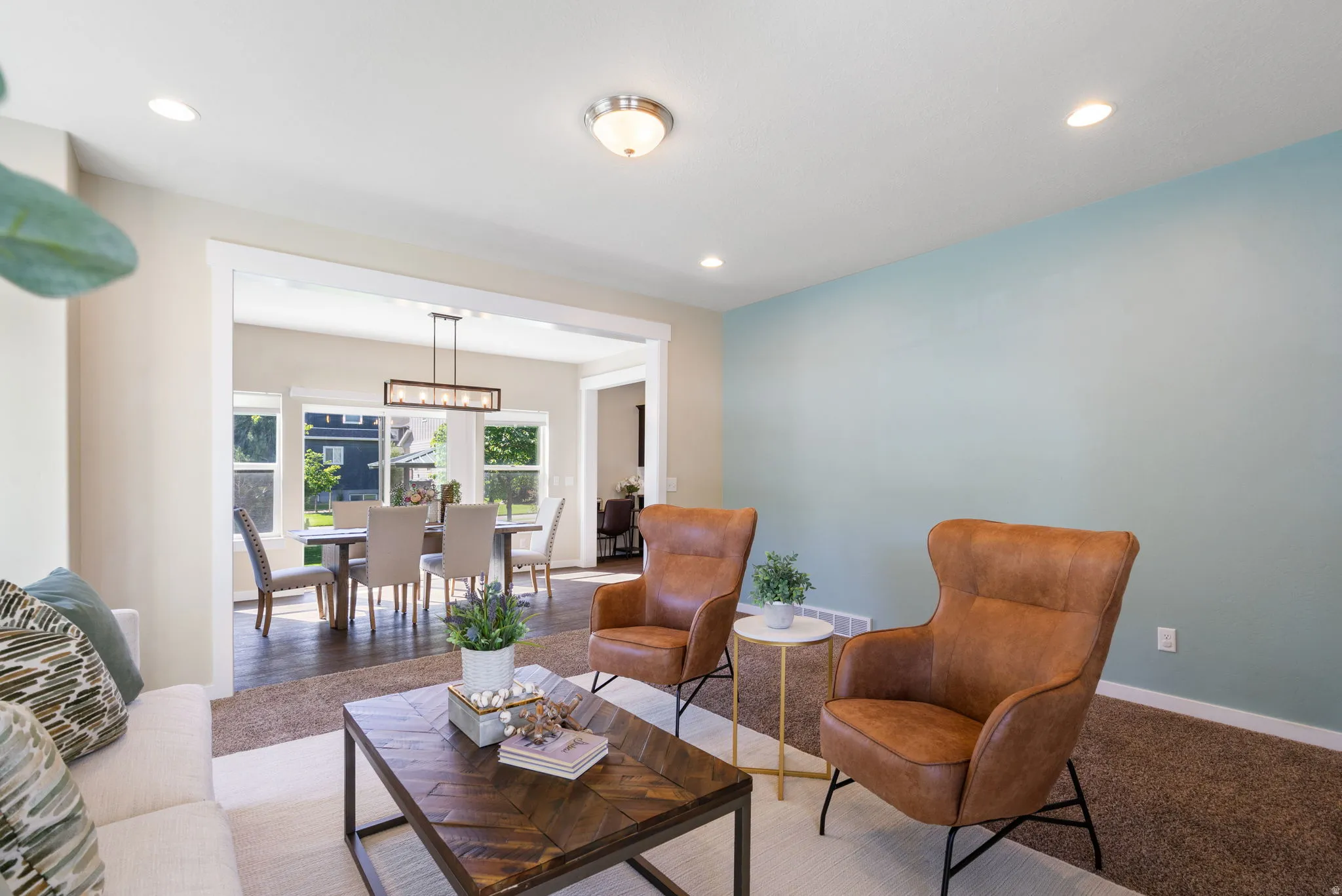 Open concept living space featuring recessed lighting and a wide cased opening to the dining area