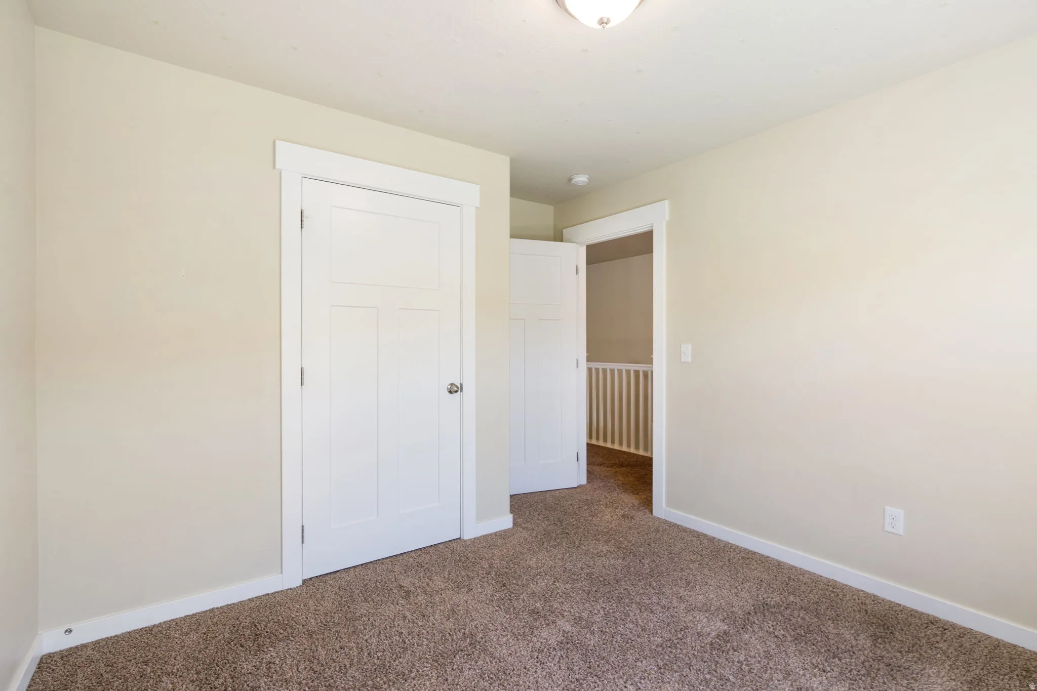 Neutral-toned walls with white trim and a white three-panel interior door