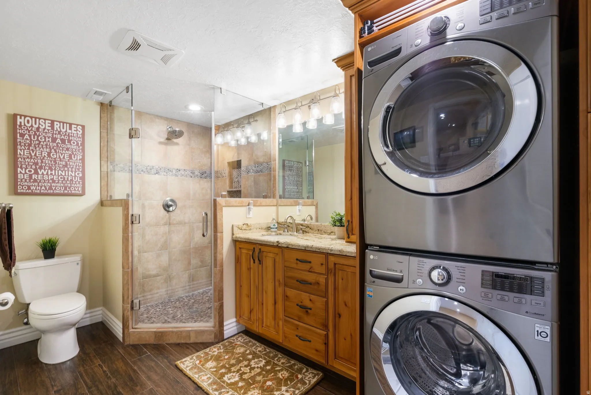 Full bathroom with extra laundry for the basement bedroom.